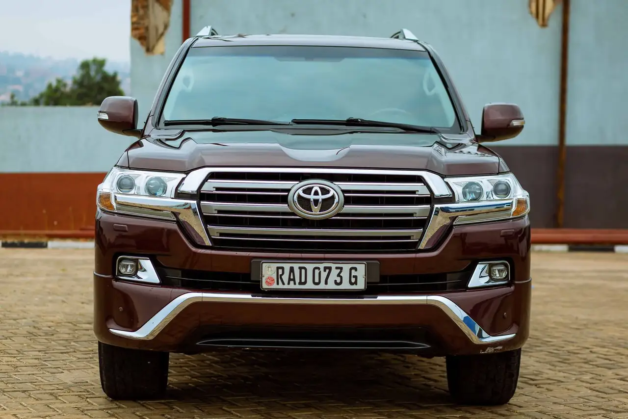 A sleek brown SUV with a visible license plate parked in an outdoor setting.